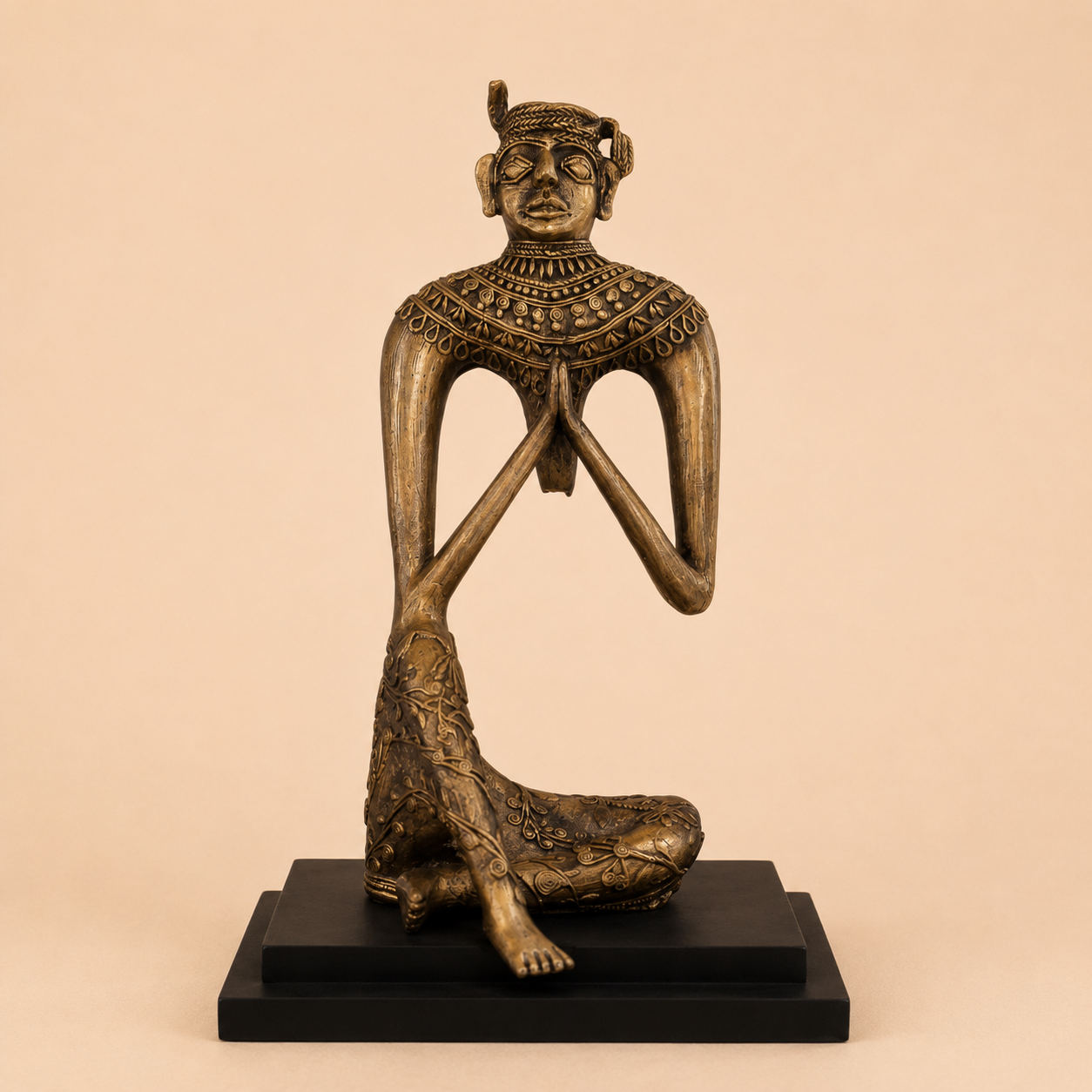 Meditative bronze statue on black base