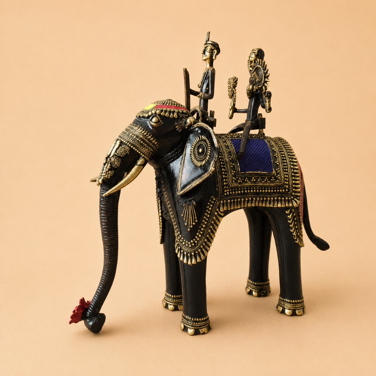 Ornate elephant sculpture with brass riders
